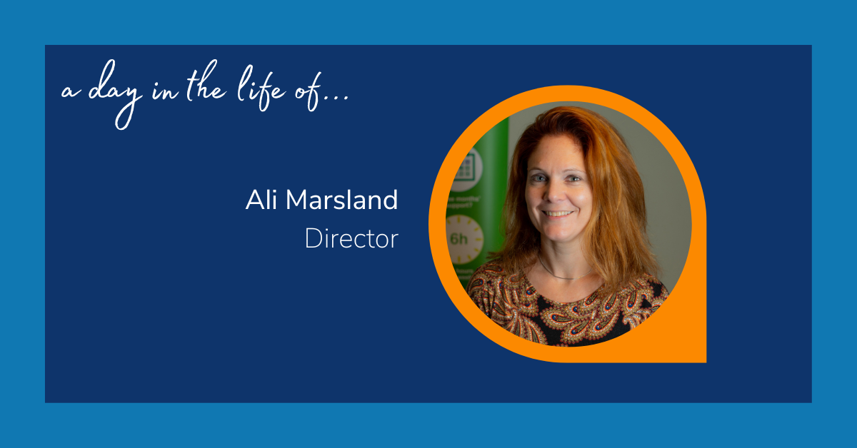Image reads: "A day in the life of... Ali Marsland: Director. The text is accompanied with an image of a woman, stood in front of a green-coloured background, smiling at the camera.