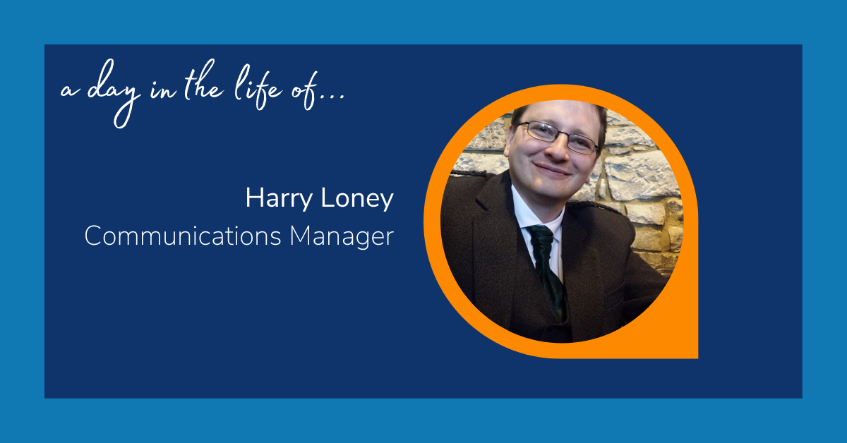 Image reads: "A day in the life of... Harry Loney: Communications Manager. The text is accompanied with an image of a man, wearing glasses and a black blazer and tie, smiling at the camera.