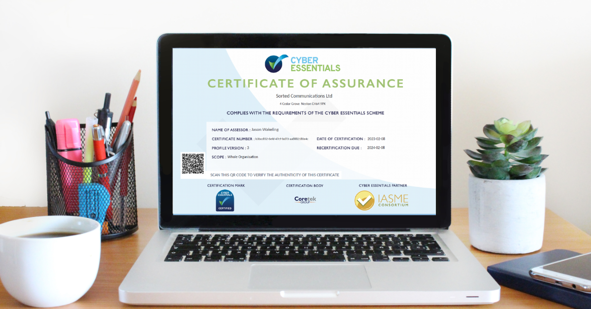 A laptop sits in the centre of the image, displaying a Cyber Essentials certificate. The certificate reads: "Cyber Essentials Certificate of Assurance. Sorted Communications Ltd. complies with the requirements of the Cyber Essentials Scheme."