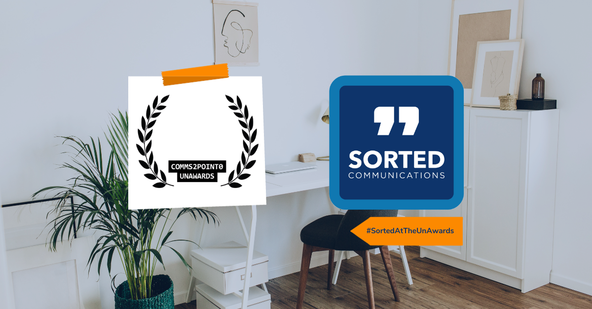 Against an image of a home office, on the left is the comms2point0 UnAwards logo and on the right is the Sorted Communications logo. Underneath the Sorted logo is a tag reading #SortedAtTheUnAwards