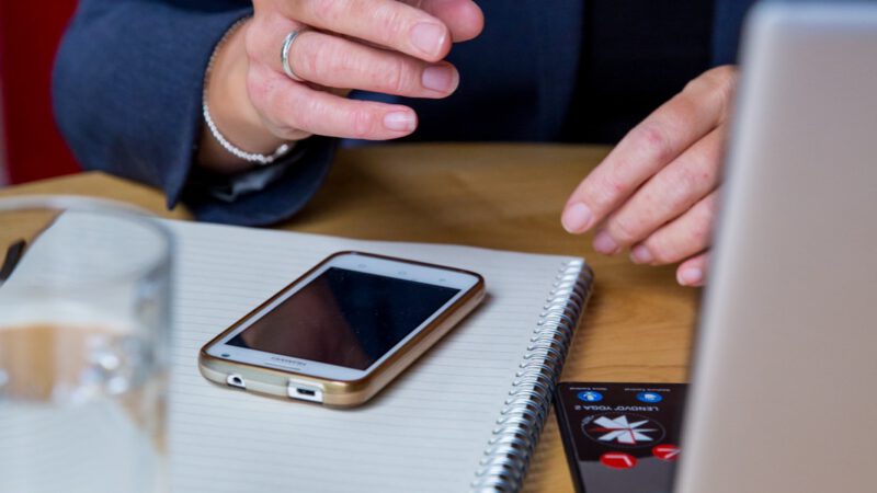 Person on video call on laptop with expressive hands